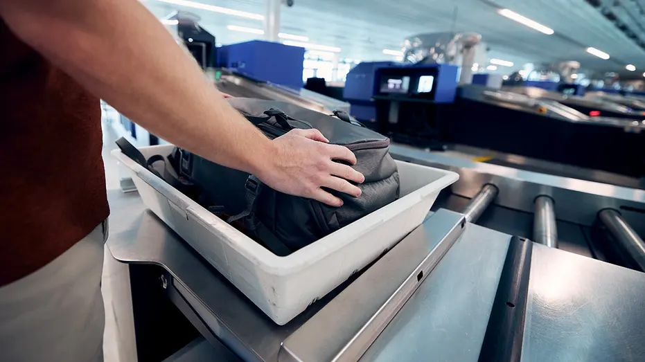 man-going-through-security-luggage
