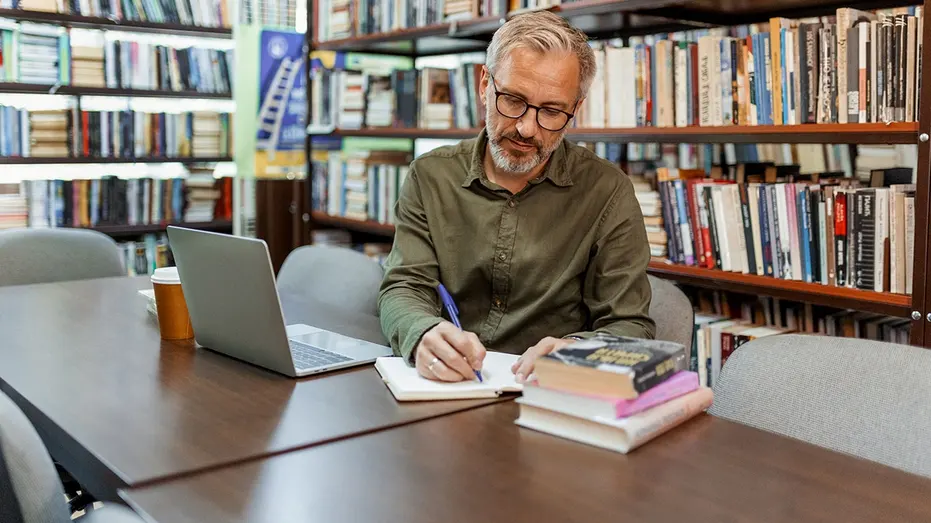 man-studying-library
