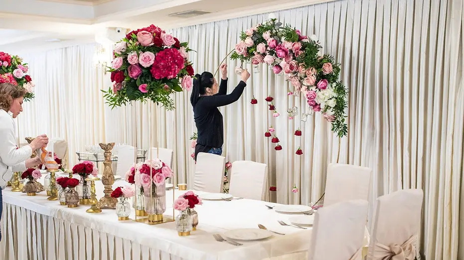 women-decorating-banquet-hall-flowers